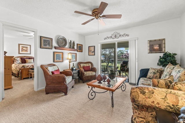 living room with light carpet, ceiling fan, and a textured ceiling