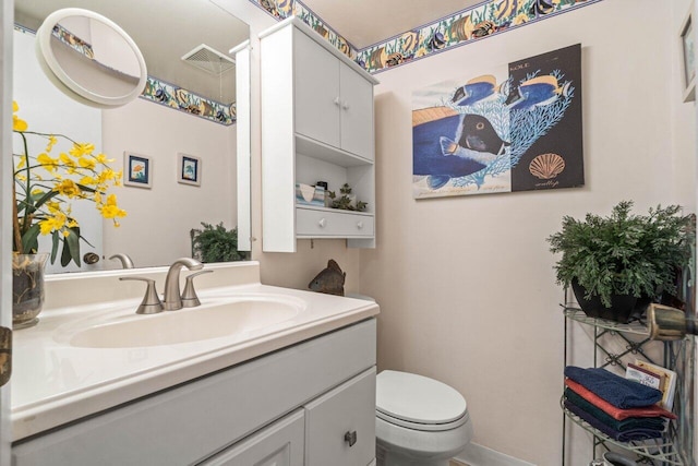 bathroom featuring vanity and toilet