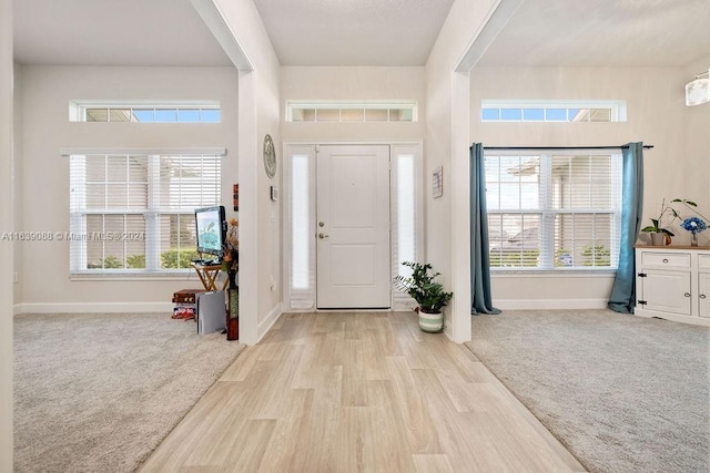 view of carpeted foyer entrance