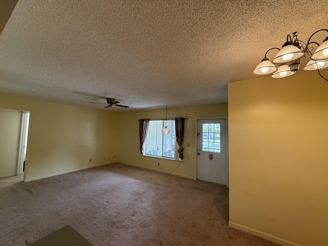 unfurnished room featuring ceiling fan, carpet, and a textured ceiling