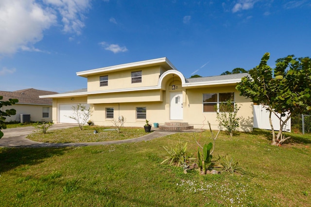 view of front of house with a garage, a front lawn, and central air condition unit