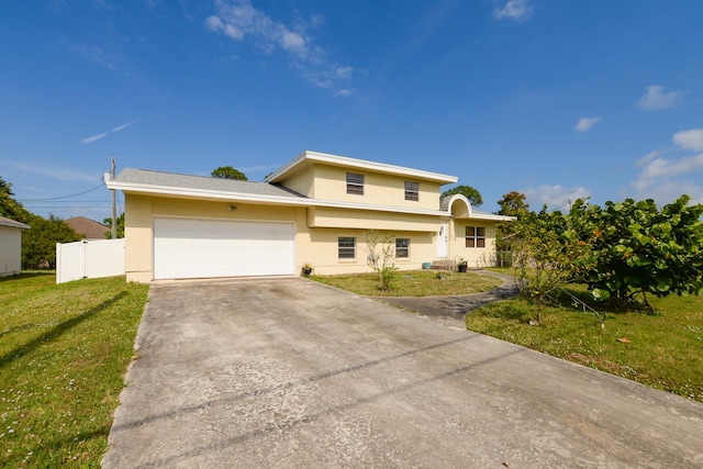 view of front of house featuring a garage and a front lawn