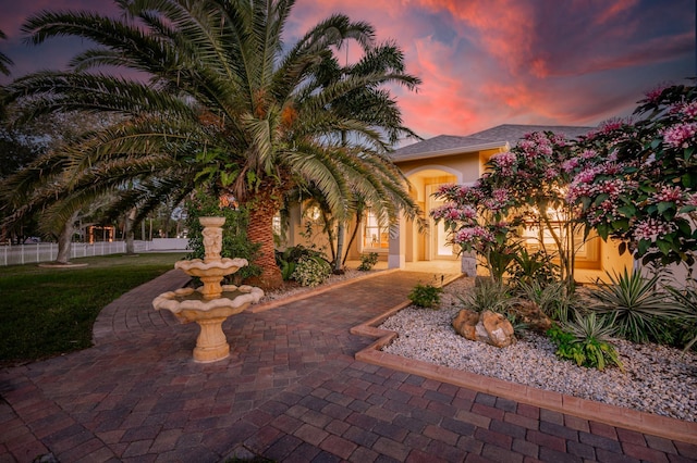 view of front of home with fence and stucco siding