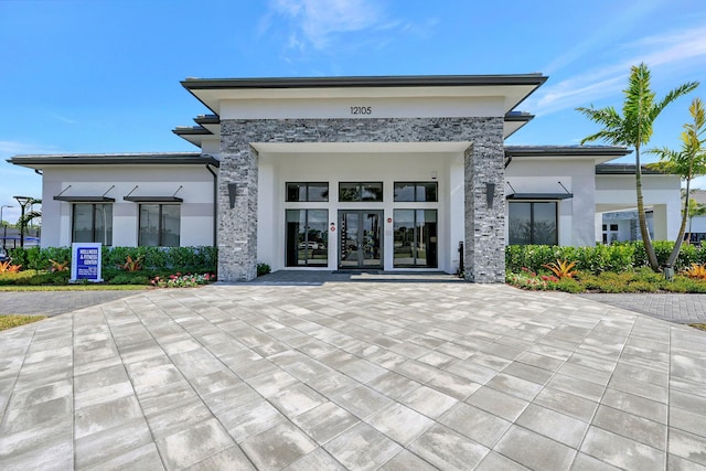 exterior space with french doors and stucco siding