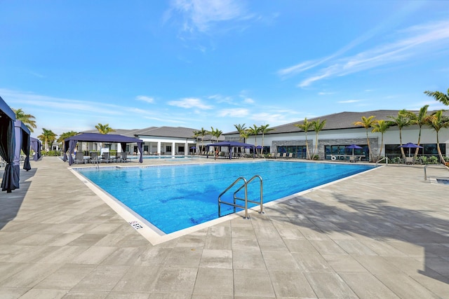 community pool featuring a gazebo and a patio