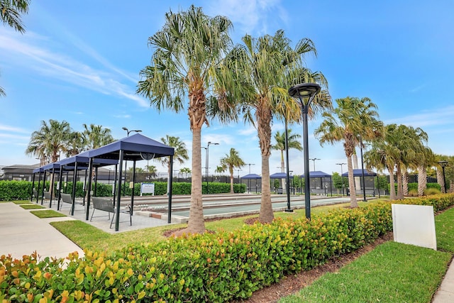 view of home's community featuring shuffleboard and fence