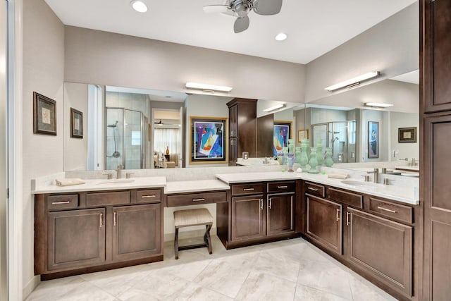 full bathroom with double vanity, a sink, a ceiling fan, and a shower stall