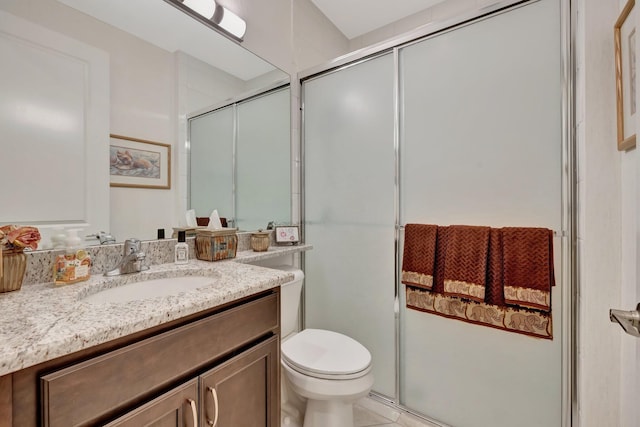 full bath featuring toilet, a shower stall, and vanity