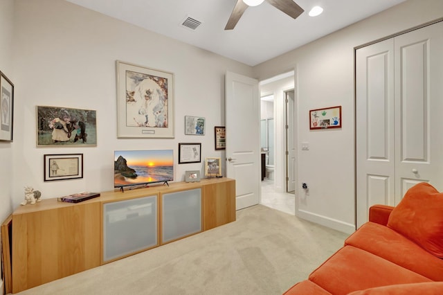 interior space with a ceiling fan, carpet flooring, visible vents, and baseboards