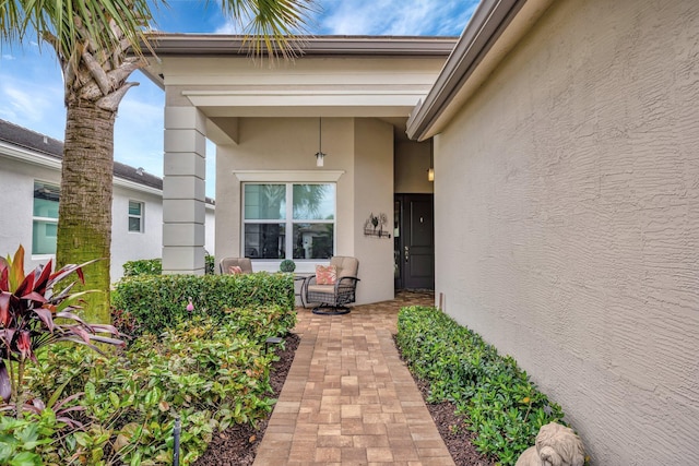 entrance to property featuring stucco siding