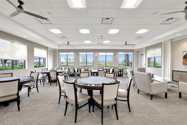 dining area with ceiling fan, visible vents, and light colored carpet