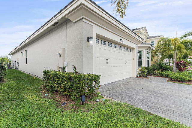 view of property exterior featuring a garage and a yard