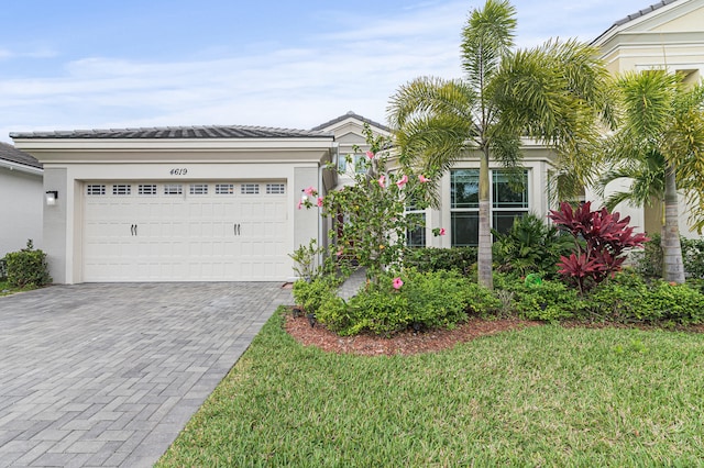 view of front facade featuring a front yard and a garage