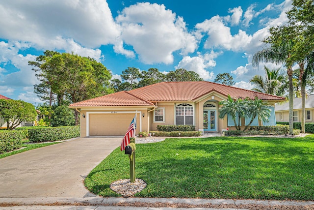 mediterranean / spanish home with stucco siding, a front lawn, concrete driveway, and a tiled roof