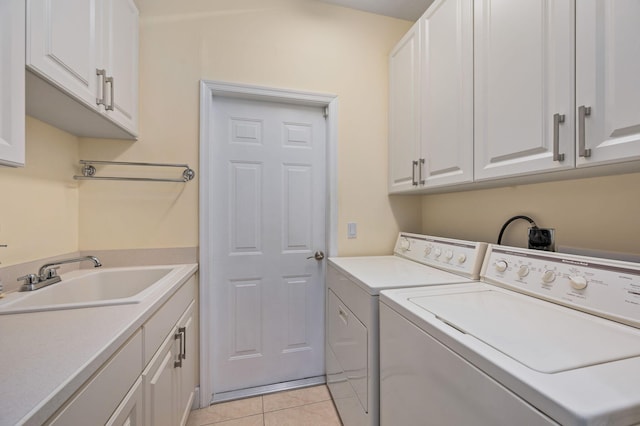 laundry area featuring sink, cabinets, independent washer and dryer, and light tile patterned flooring