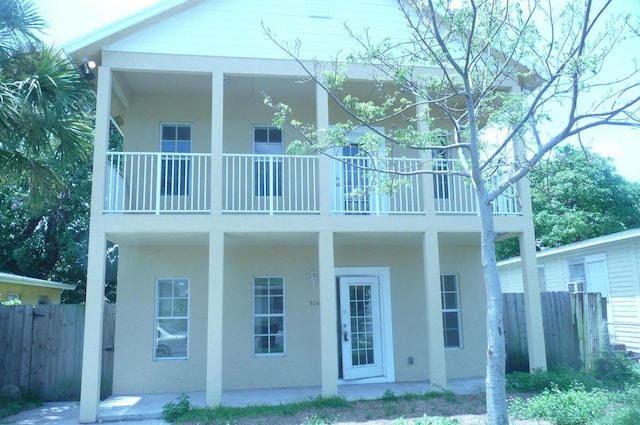 rear view of property featuring a balcony