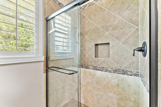 interior details featuring a shower with shower door