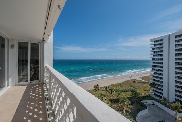 balcony featuring a water view and a beach view