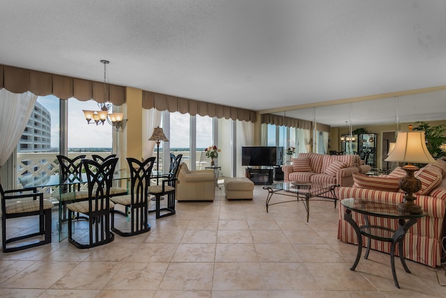 living room featuring a view of city, light tile patterned flooring, a notable chandelier, and a textured ceiling