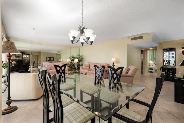 dining room featuring crown molding, visible vents, and a notable chandelier