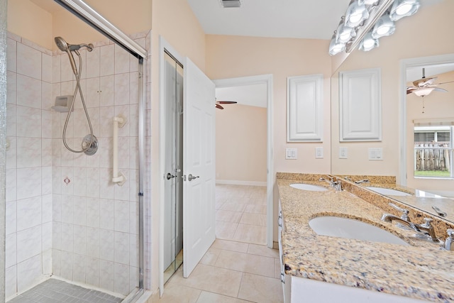 bathroom with tile patterned flooring, vanity, a shower with shower door, and ceiling fan