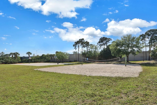 view of property's community with a yard and volleyball court