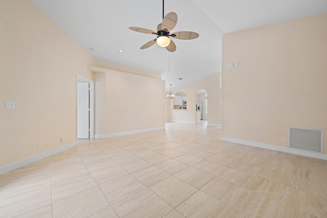 empty room featuring ceiling fan with notable chandelier and light tile patterned flooring