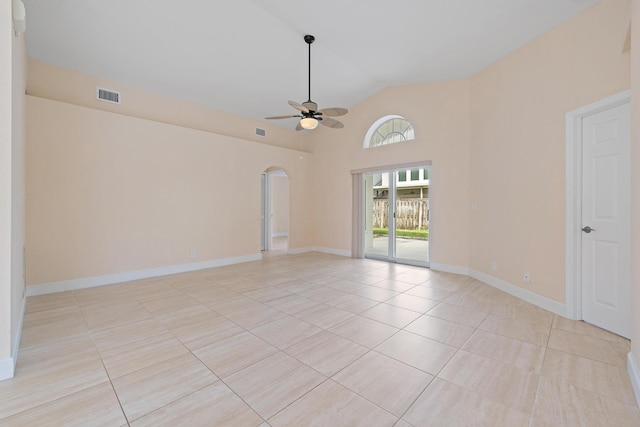 spare room with light tile patterned flooring, high vaulted ceiling, and ceiling fan