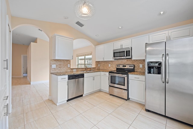 kitchen featuring sink, appliances with stainless steel finishes, light stone counters, white cabinets, and light tile patterned flooring