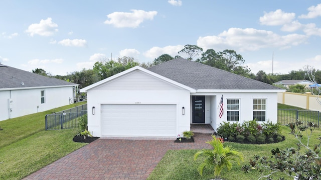 single story home featuring a garage and a front lawn