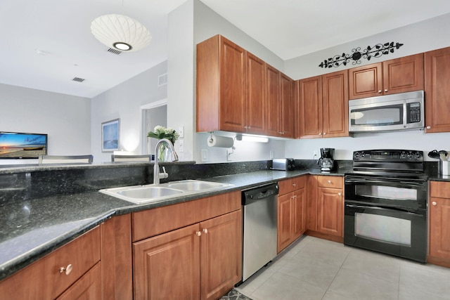 kitchen with stainless steel appliances, sink, hanging light fixtures, and light tile patterned floors