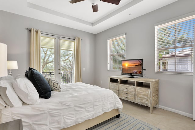 tiled bedroom featuring a raised ceiling, access to outside, and ceiling fan