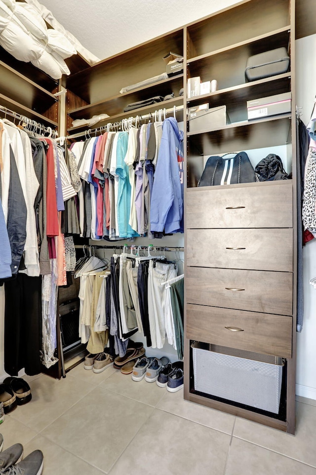 walk in closet featuring light tile patterned flooring