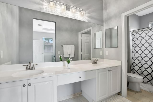 bathroom with vanity, curtained shower, tile patterned floors, and toilet