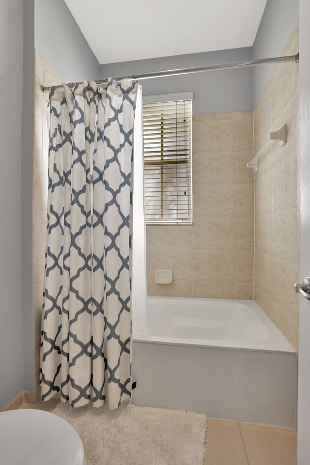 bathroom featuring shower / bath combination with curtain, toilet, and tile patterned flooring