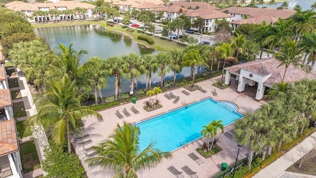 view of pool featuring a water view and a patio