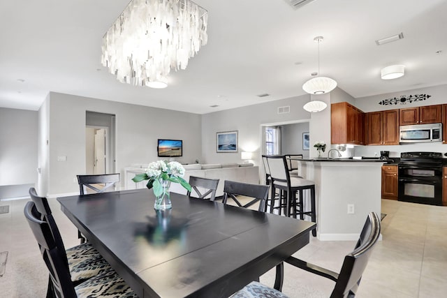 dining area with sink and light tile patterned floors