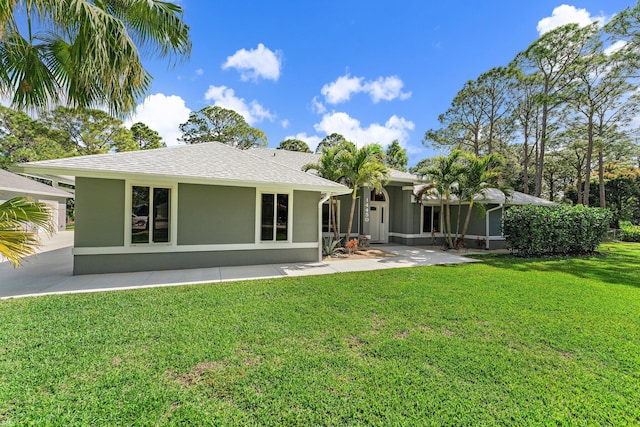 rear view of property with a yard