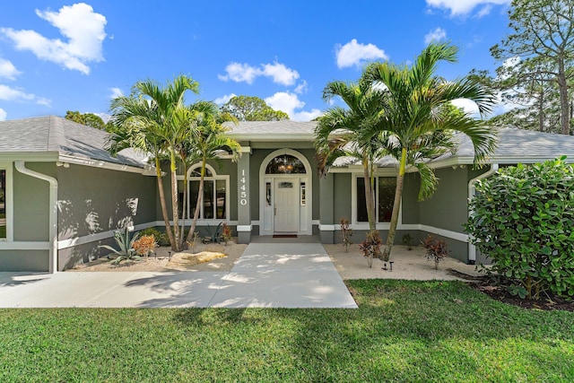 doorway to property featuring a yard