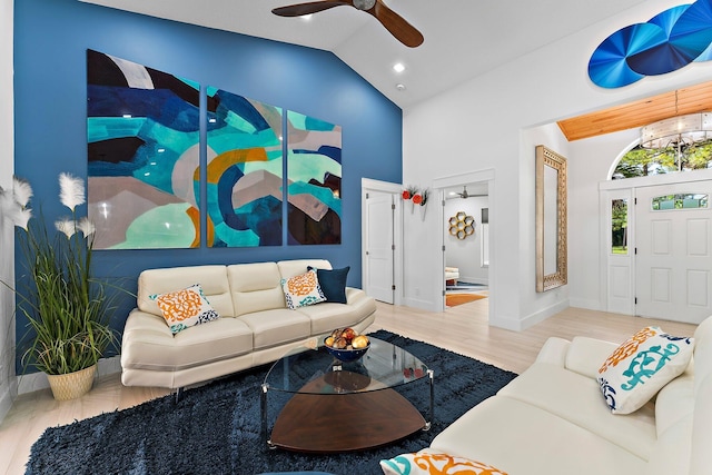 living room featuring ceiling fan, wood-type flooring, and high vaulted ceiling