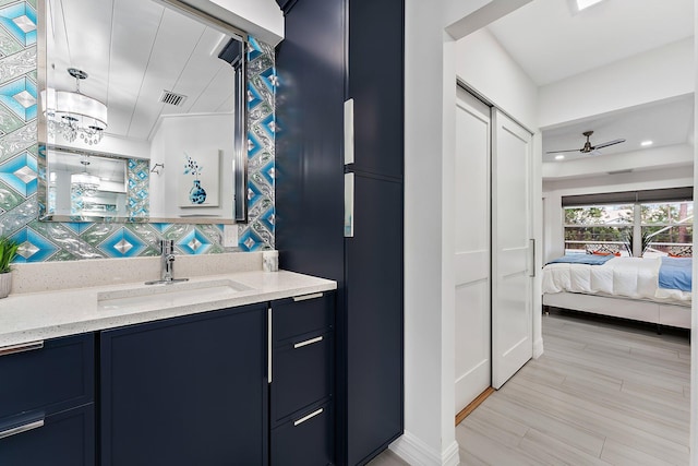 bathroom with vanity, hardwood / wood-style floors, and ceiling fan