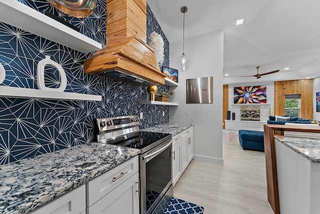 kitchen featuring white cabinets, stainless steel range with electric cooktop, and stone counters