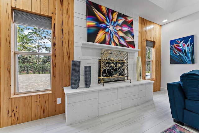 living room with a wealth of natural light and wood walls