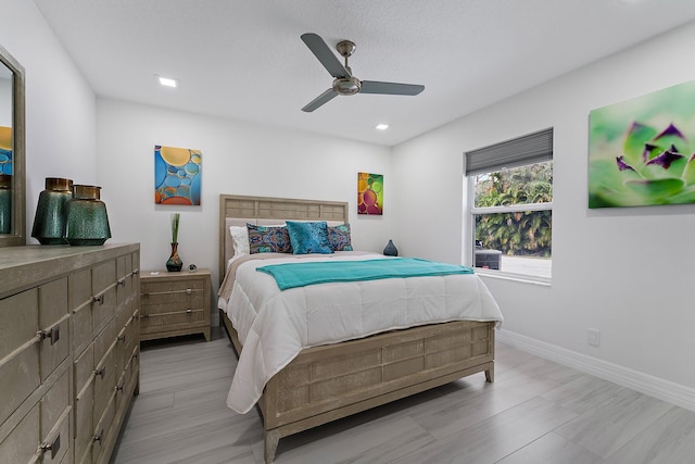 bedroom with ceiling fan and light hardwood / wood-style flooring