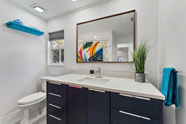 bathroom featuring vanity, toilet, and a shower with shower curtain