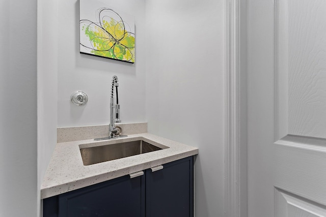 bathroom featuring light stone countertops and sink