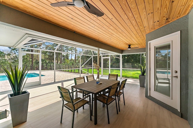 sunroom / solarium with wooden ceiling and ceiling fan