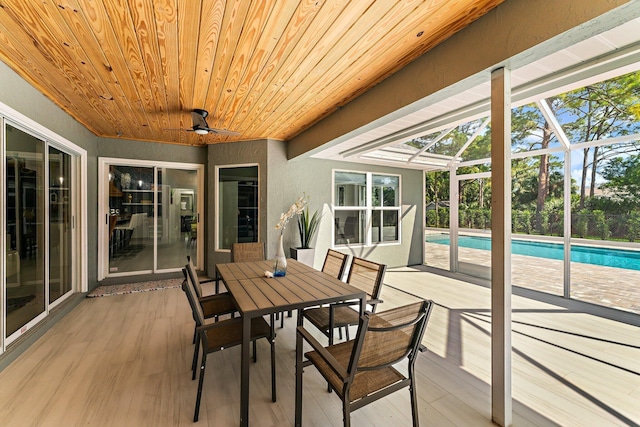 sunroom / solarium with wood ceiling and ceiling fan