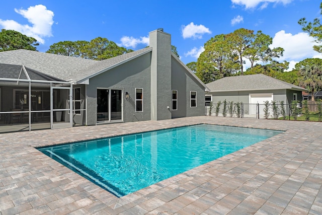 view of swimming pool with a patio and glass enclosure