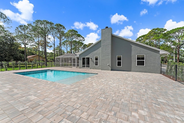 view of swimming pool with a lanai and a patio area